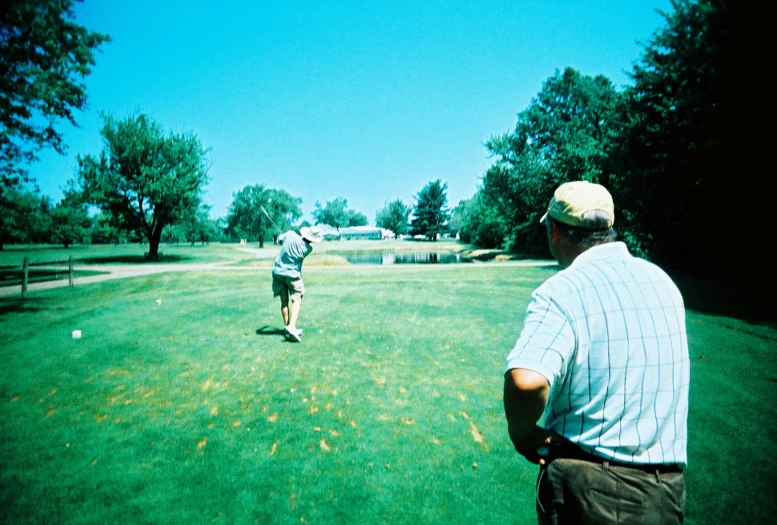 two men in a field playing with a disc