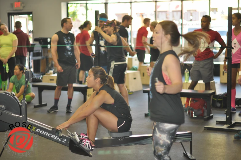 women in sports apparel are having a conversation while they are working out on benches