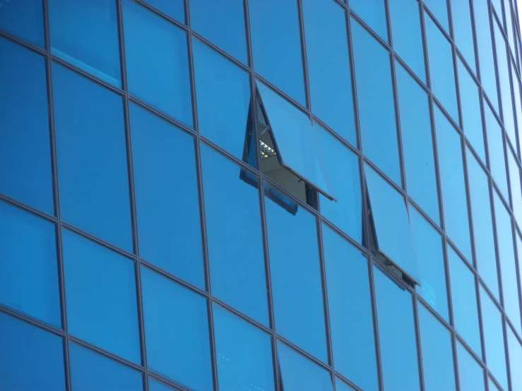 the airplane is flying low to the surface of a building