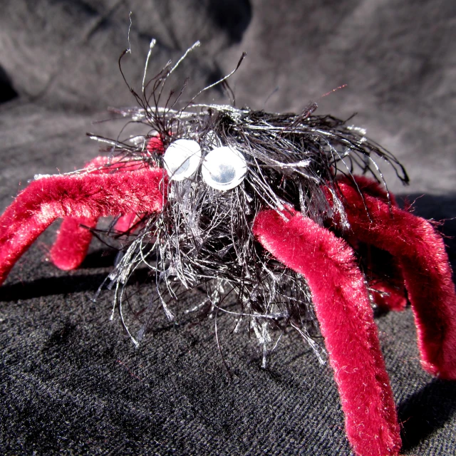 the head and legs of a small toy spider