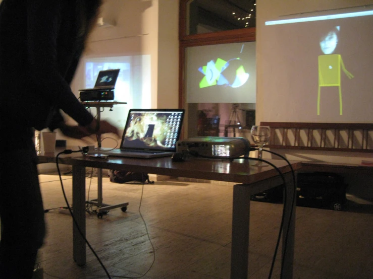 a wooden table with two lap top computers on it