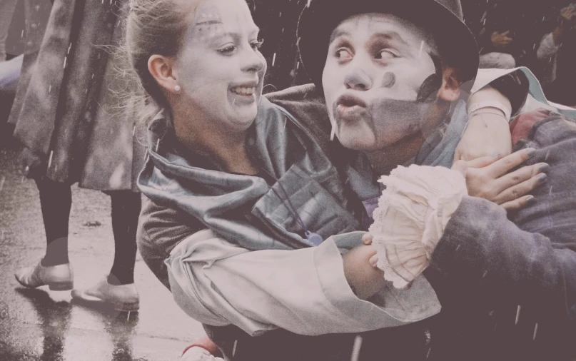 two people with painted face on holding an umbrella