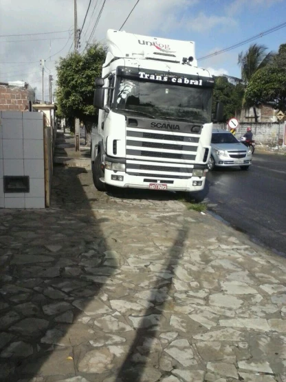 the truck has stopped on a cobblestone street