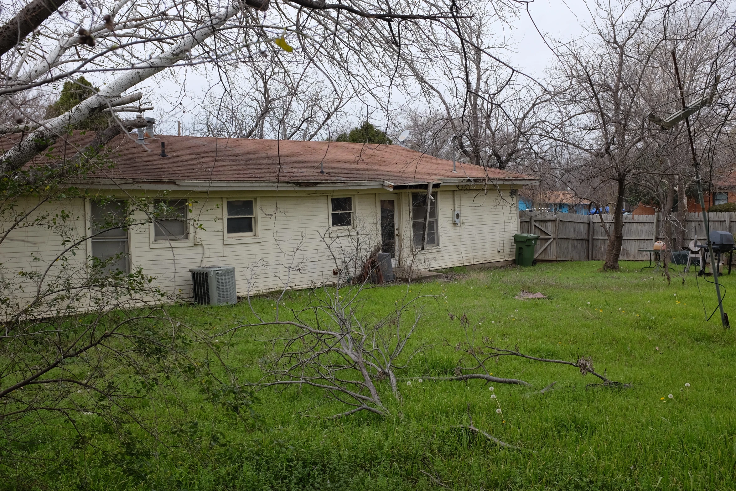 the back yard with the small shed is empty