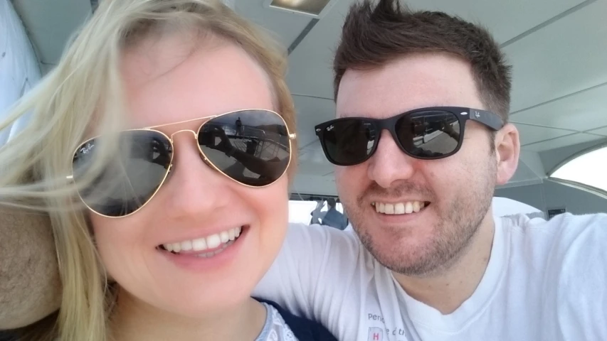 a man and woman are sitting together wearing glasses