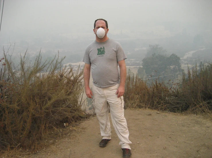 a man wearing a mask on a dirt road