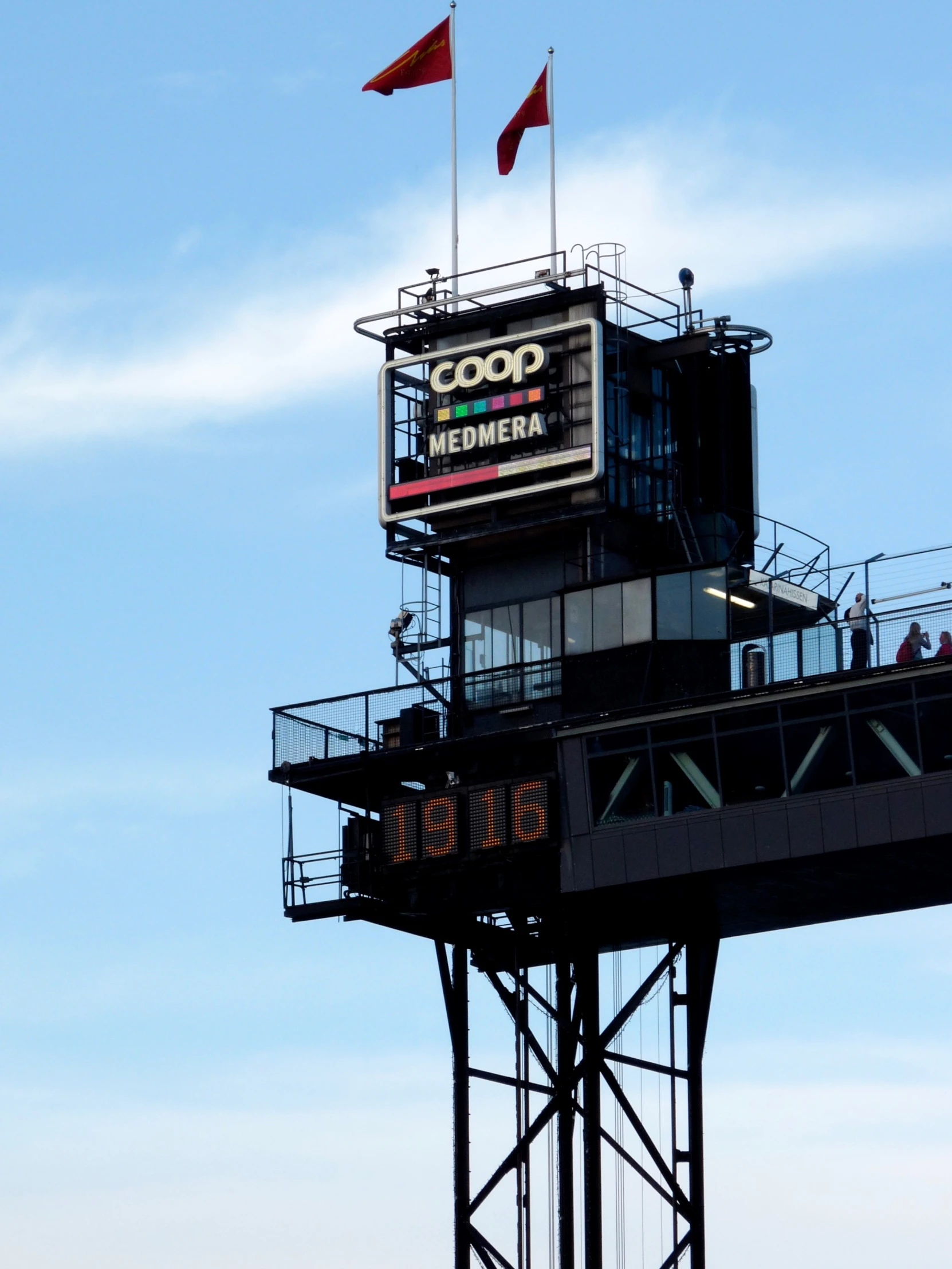 a large air port control tower with flags flying