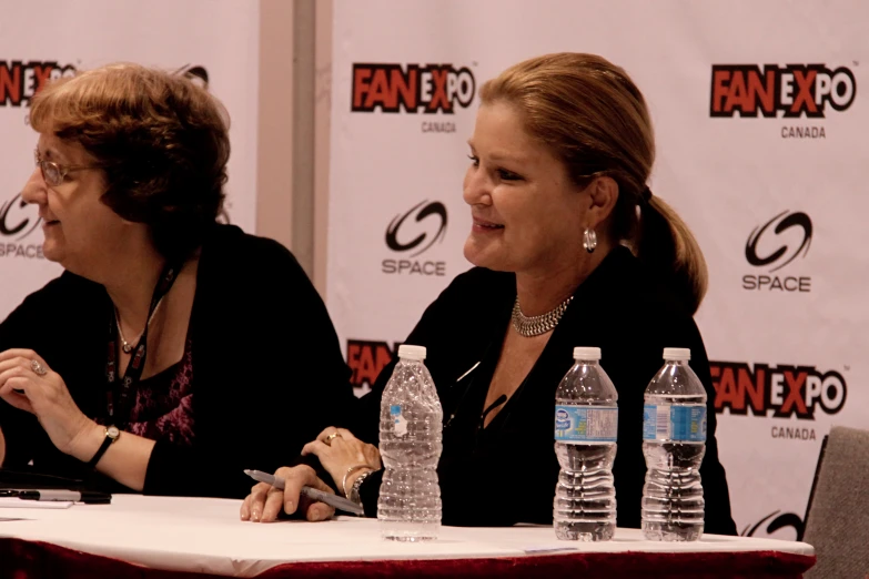 two women talking about a topic at an event