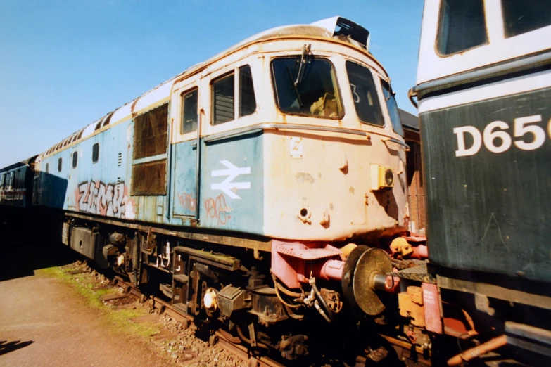 a old abandoned train car is parked in the sun