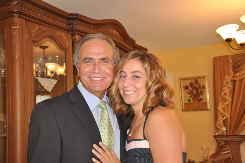 a woman and man standing next to each other in a room