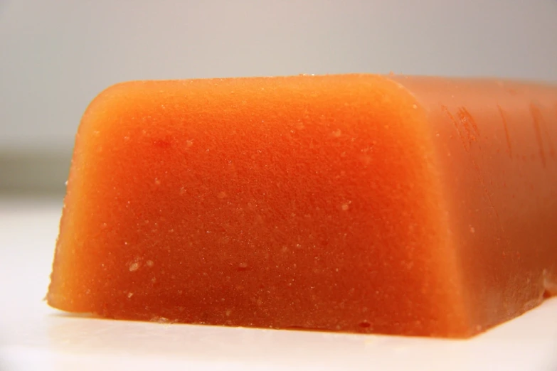 close up of a piece of soap on white surface