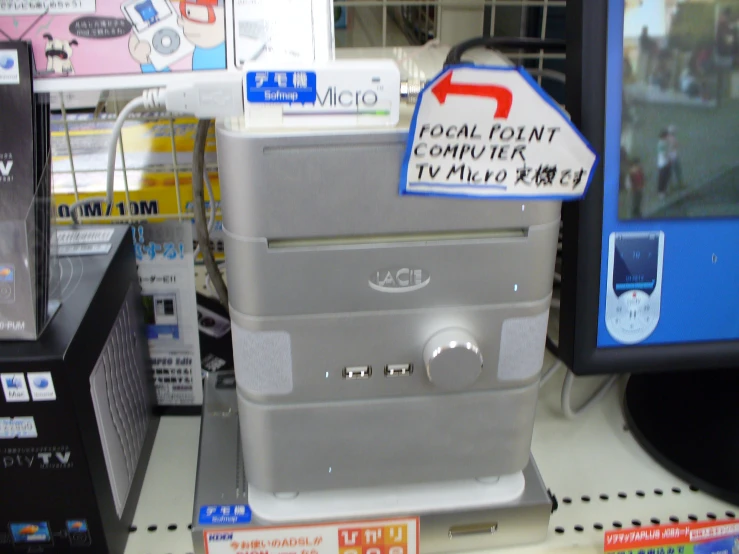 electronic equipment displayed on store shelf with business card on the shelf