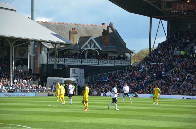 a soccer game is being played on a large field