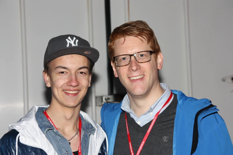 two young men smile for a po together