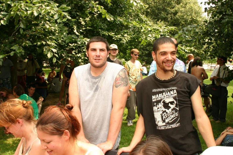 a bunch of men sitting around with their arms around one another