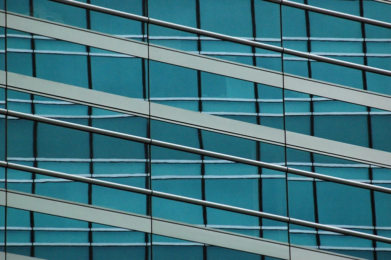 an airplane is flying behind the glass windows of a building