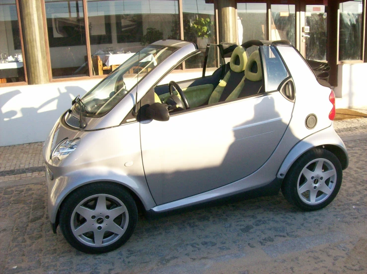 a small car parked on the side of a road