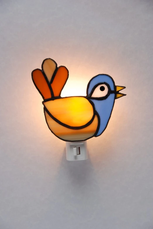 a small light shaped like a bird is mounted on the wall