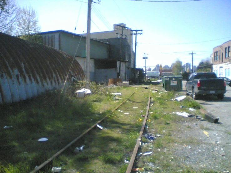 an old railroad tracks next to an industrial building