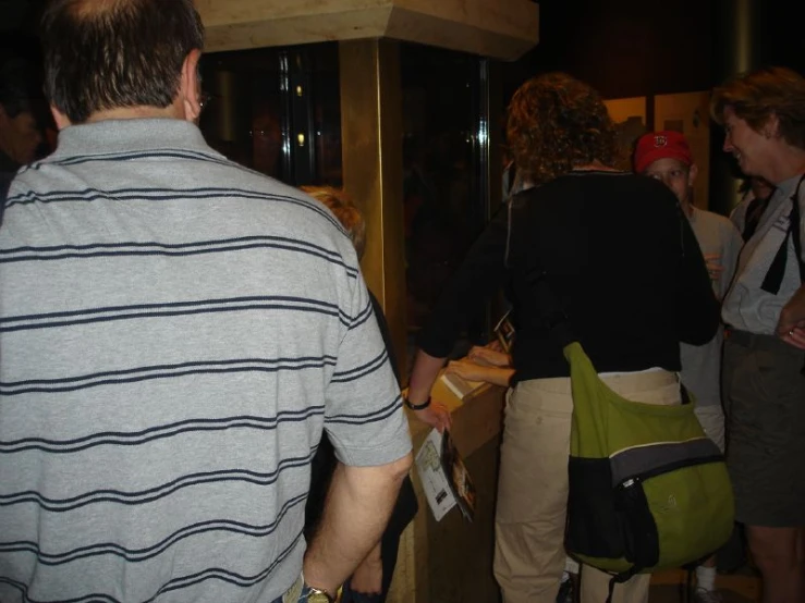 a group of people are standing in a room with suitcases