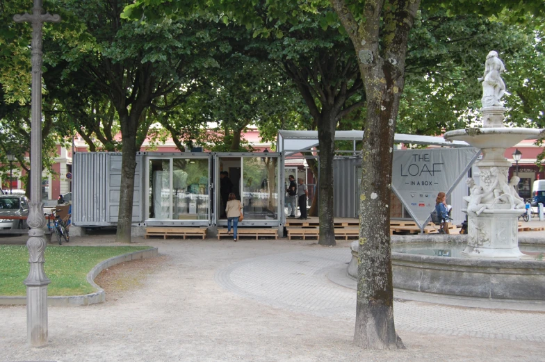 a man standing in front of a container that's built into the sidewalk