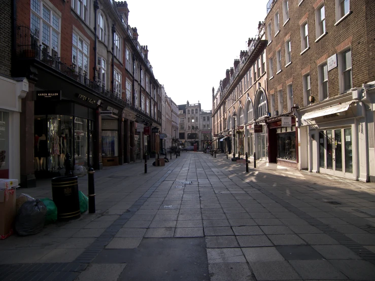 an empty street in a residential area with tall buildings