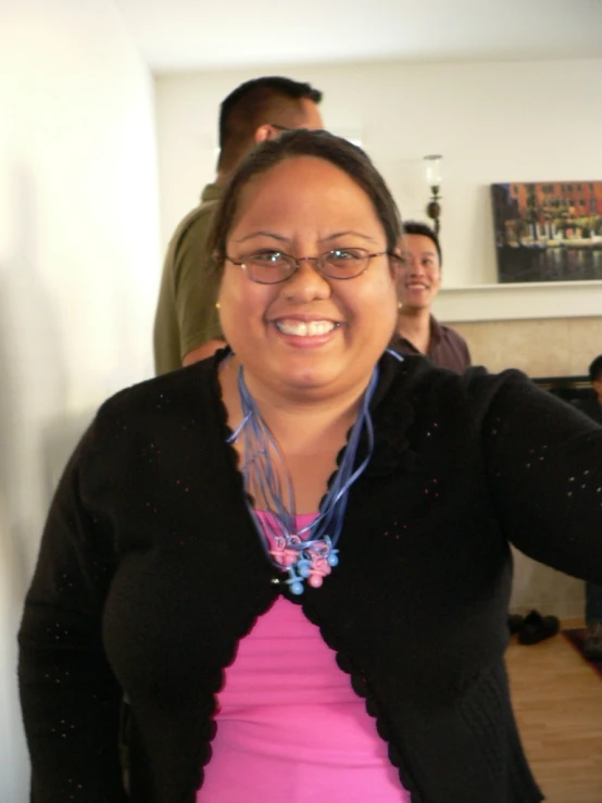 woman wearing a pink top in a room