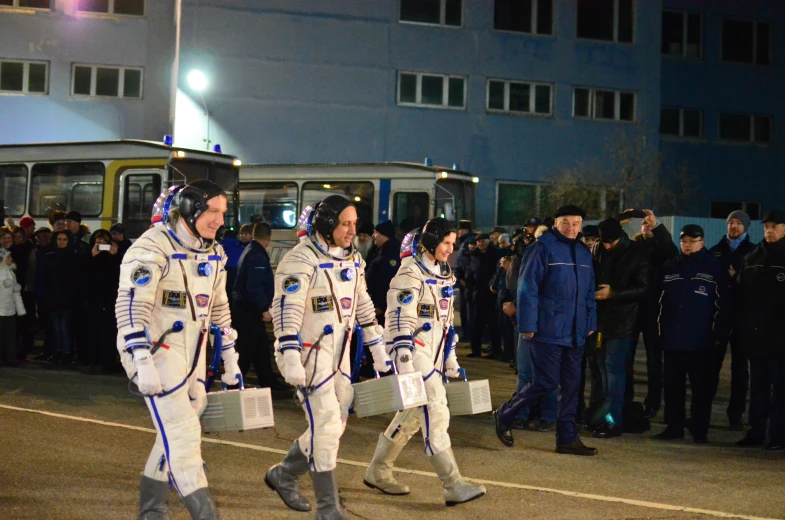 people in space suits walking down the street