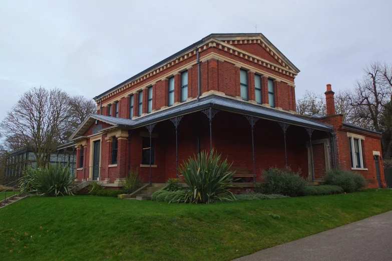 the house is red brick with an iron roof