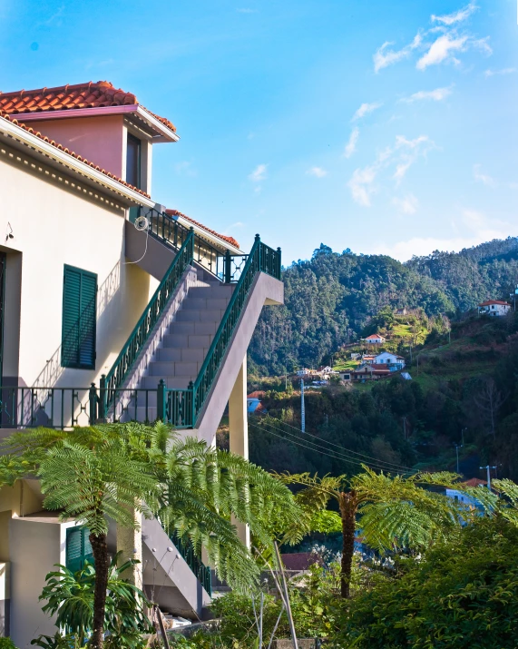 a building on a hill with an attached deck