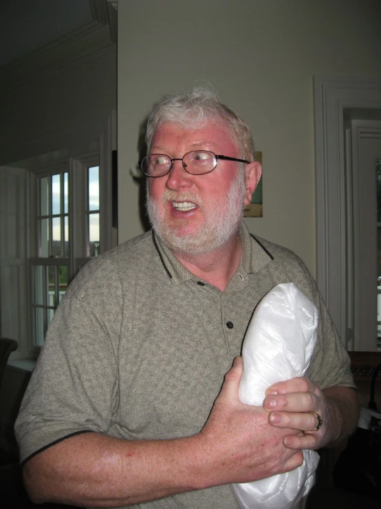 a man holding a bag and wearing glasses