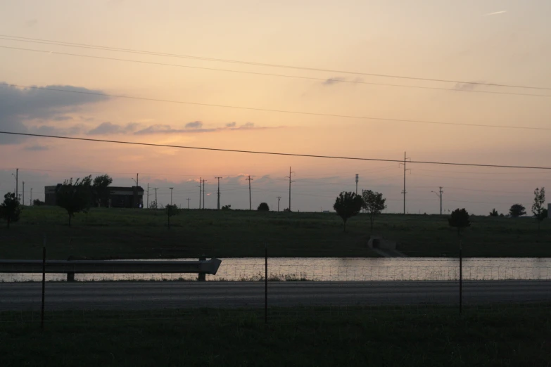 a river at sunset by a road