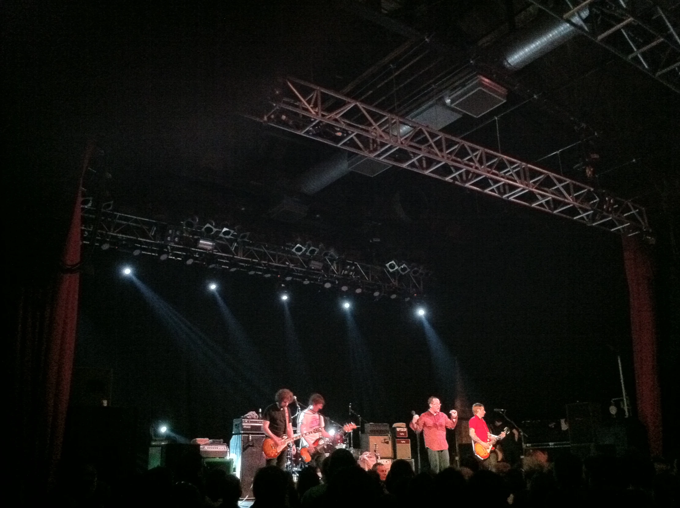 band on stage performing on a dark night