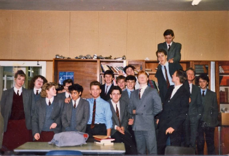 young people in suits and ties pose for a picture