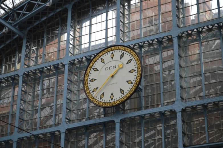 a large clock is on a metal structure