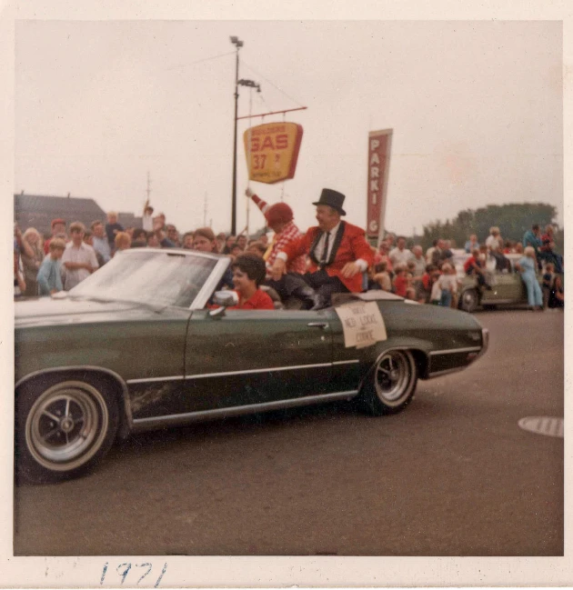 two men are sitting in the back of a car