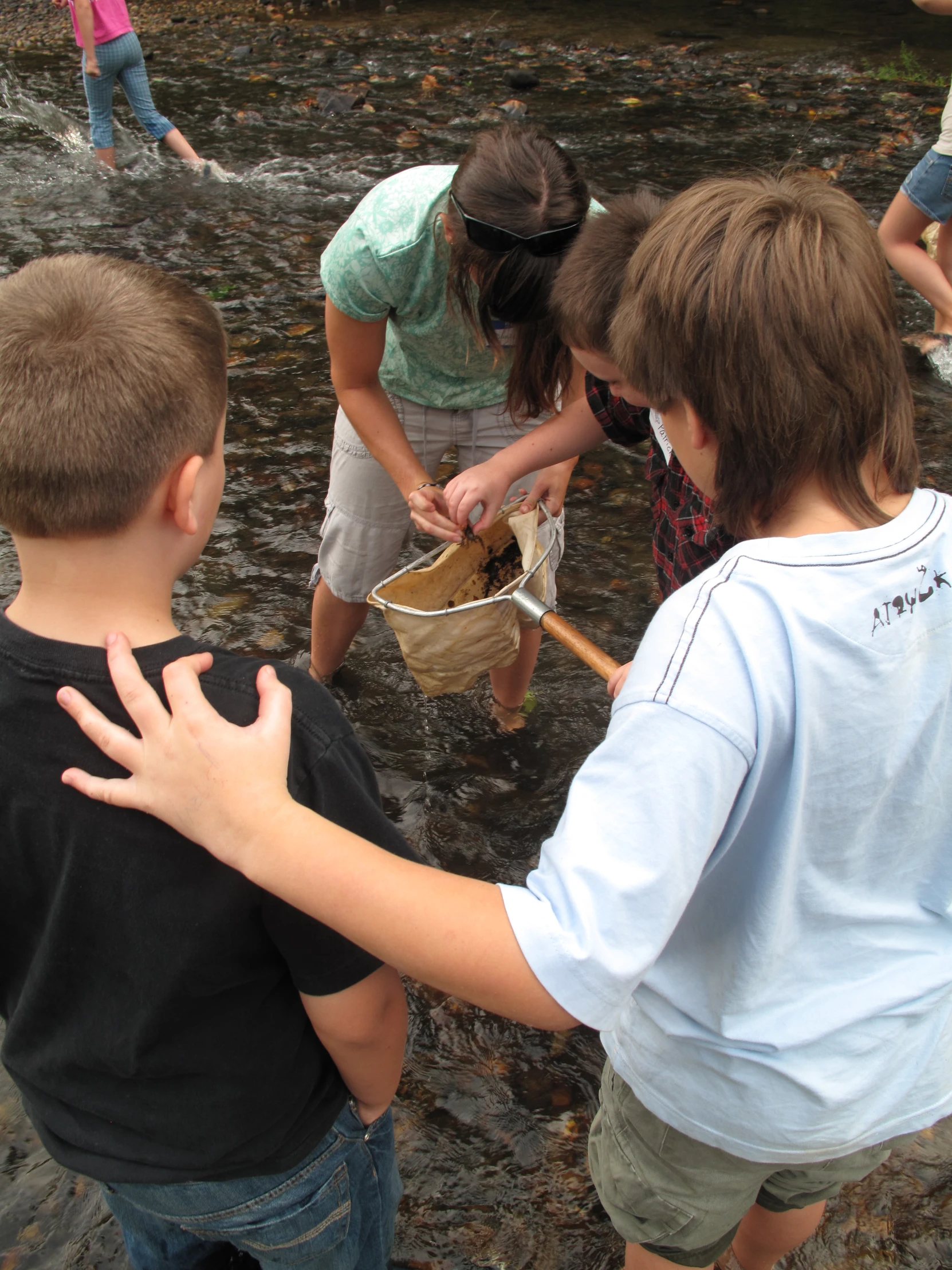 several people with two hands out towards a group of others