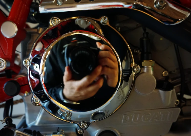 there is a man holding a camera in front of a bike