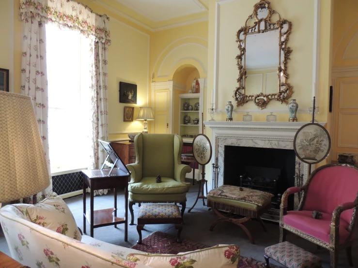 a living room with several chairs, a couch, and a fireplace