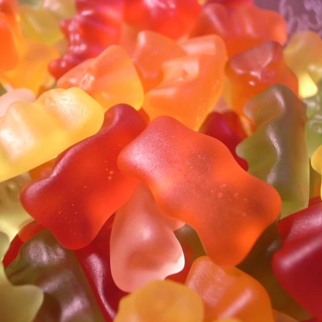 several large gummy bears lined up on top of each other