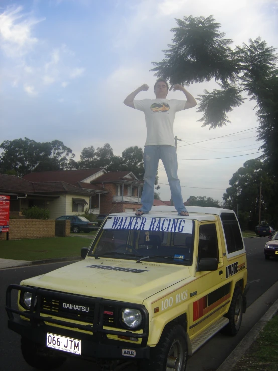 there is a yellow pickup truck with a fake fake man on the top