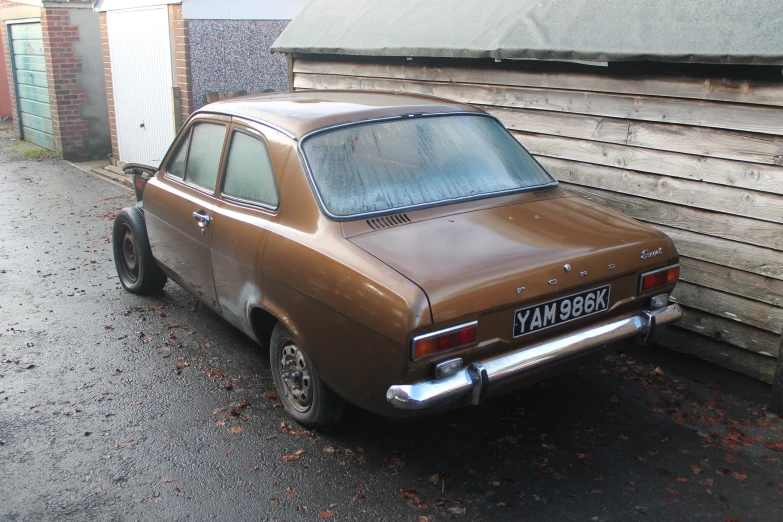 old car parked near a building in a village