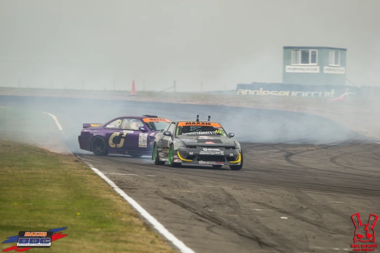 two cars racing at the same time on a track