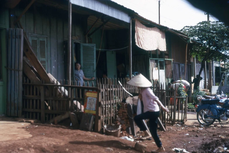 people in the back yard of an old building