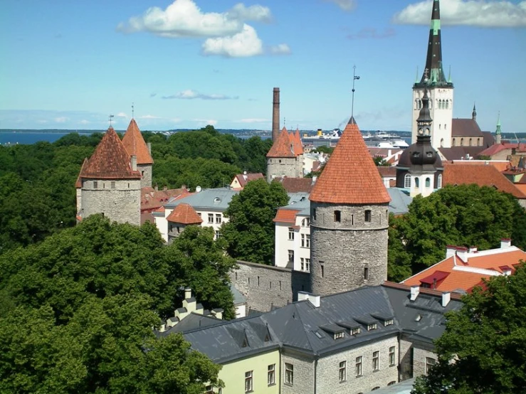 the rooftops of some buildings near trees