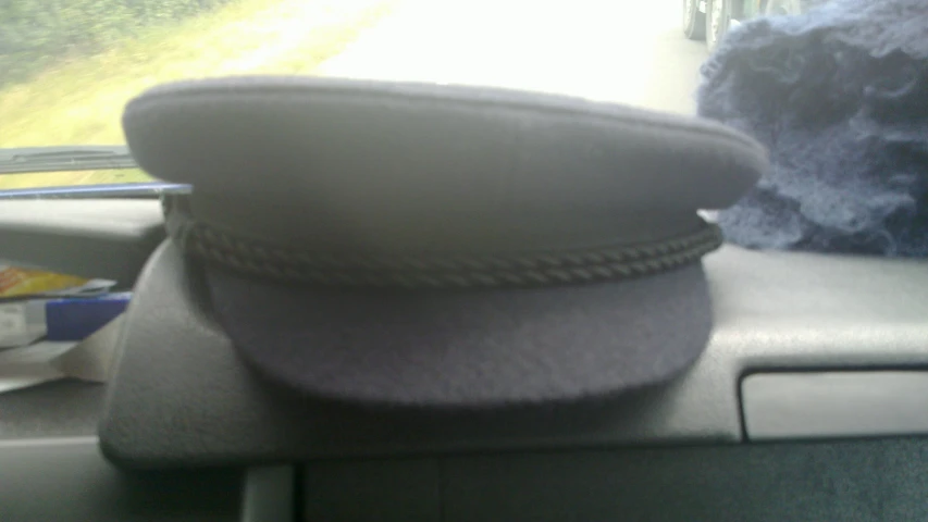 two hats are placed on the dashboard of a car