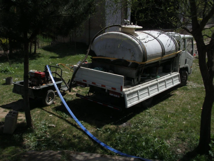 the back of a truck has a gas tank attached to it