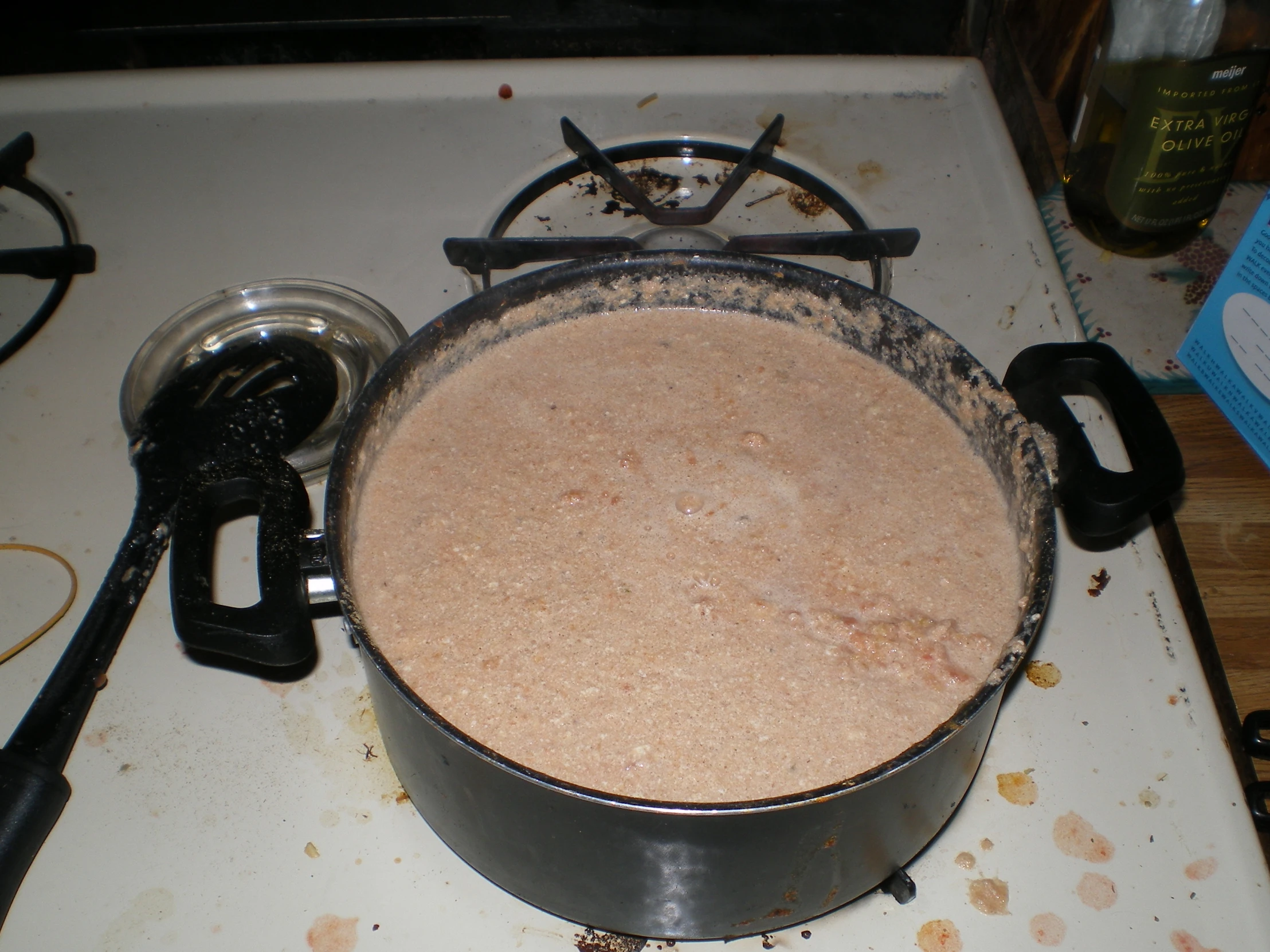 an old metal pot is cooking on the stove