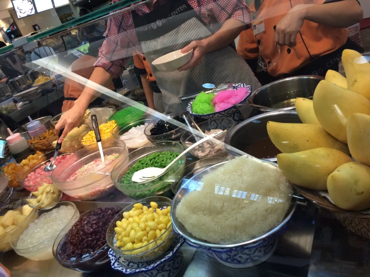 bowls of food in front of two chefs