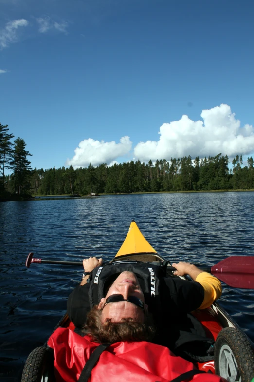 the man is riding on a boat in the water